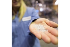 Plastic resins in hand.